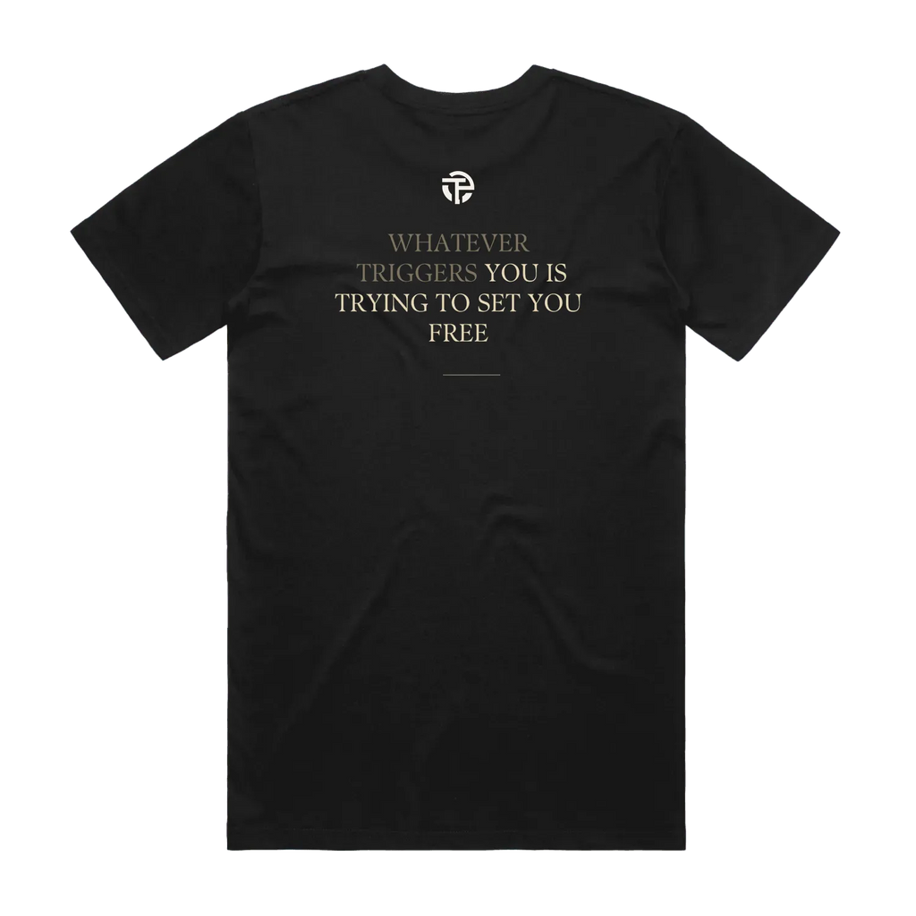 Triggers Set Free tee back — the quote 'Whatever triggers you is trying to set you free' on a black TPC tee