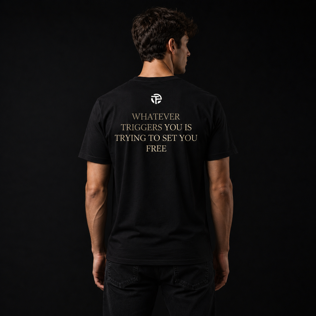 Model wearing the TPC Triggers Set Free black tee, back view with the quote