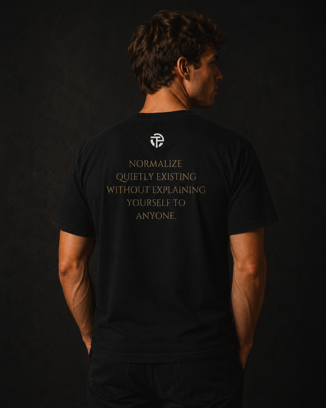 Model wearing the TPC Quietly Existing Variant B black tee, back view with the quote