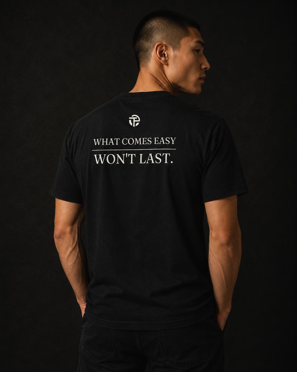 Model wearing the TPC What Comes Easy black tee, back view with the quote
