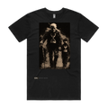 Time Flies black t-shirt front — TPC tee with a grandfather and a child each holding an hourglass