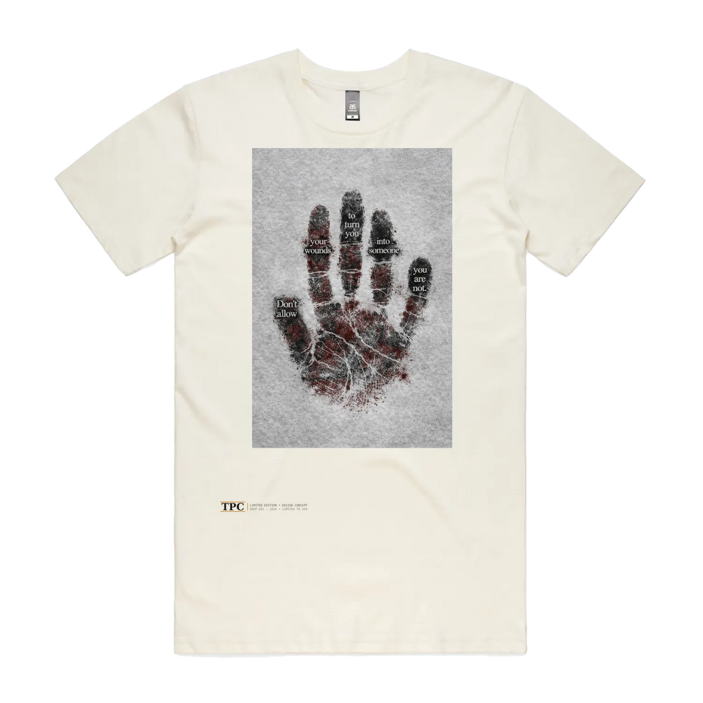 Wounds t-shirt front — TPC tee with a bloodied handprint and the words 'Don't allow your wounds to turn you into someone you are not'